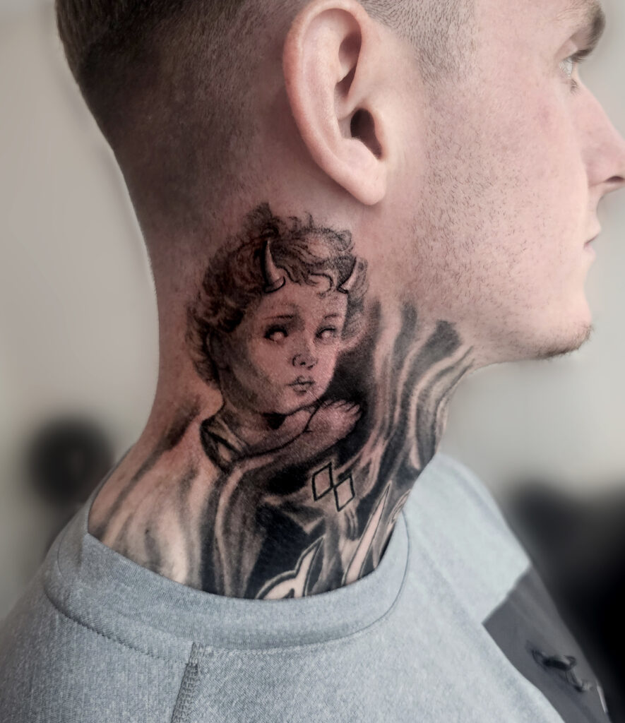 Black and grey portrait tattoo on neck
