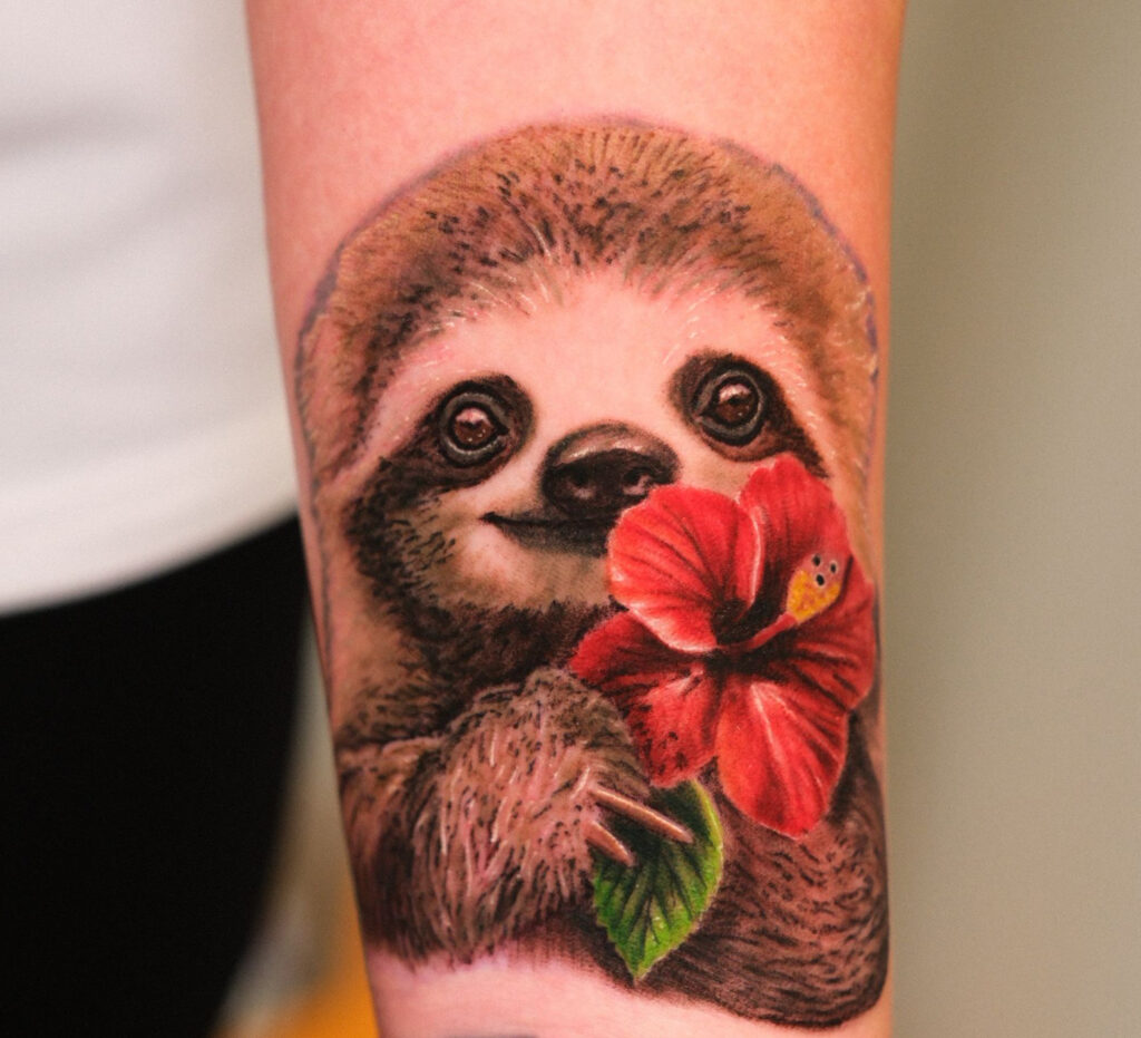 Small colour realism sloth tattoo with hibiscus flower